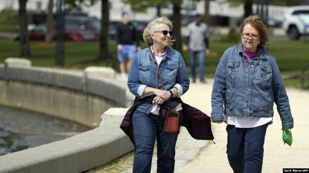 Donna Anderson, left, walks with her friend Christine White, Tuesday, April 27, 2021, in Olympia, Wash. (AP Photo/Ted S. Warren)