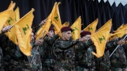 File - Hizballah fighters attend a funeral procession.