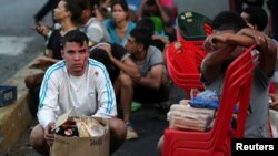 People detained by security forces after looting broke out during an ongoing blackout are pictured in Caracas, Venezuela, March 10, 2019.