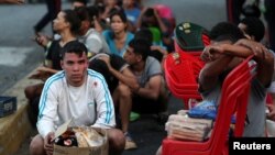 People detained by security forces after looting broke out during an ongoing blackout are pictured in Caracas, Venezuela, March 10, 2019.