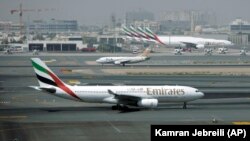 In this Tuesday April 20, 2010 file photo, an Emirates airline passenger jet taxis on the tarmac at Dubai International airport in Dubai, United Arab Emirates. . (AP Photo/Kamran Jebreili, File)