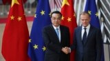 China's Premier Li Keqiang, left, shakes hands with European Council President Donald Tusk during an EU-China summit at the European Council headquarters in Brussels, Belgium, April 9, 2019.