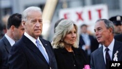 US Vice President Joe Biden (L) stands next to his wife Jill Biden and New York Mayor Mike Bloomberg (R) before dropping flowers into a reflecting pool in the middle of Ground Zero at the memorial service September 11, 2010 in New York City