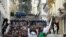 FILE - Algerian security forces form a human barrier as anti-government protesters take to the streets of the capital Algiers, as the Hirak pro-democracy movement gathers renewed momentum, Feb. 26, 2021.