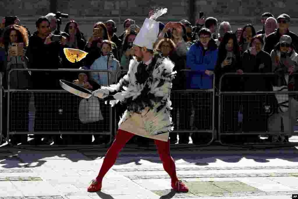 A runner competes during a traditional pancake race by livery companies at the Guildhall in London.