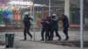 A police officer escorts a group of detained protesters in Almaty, Kazakhstan, Jan. 6, 2022. 