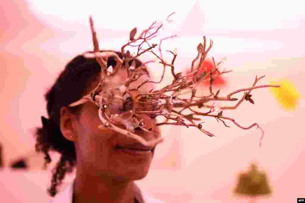 French accessories designer Sandrine Paskusz-Koffi presents a model of sunglasses created with French accessories designer Thibaut Rodde during the 32nd edition of the International Festival of Fashion and Photography in Hyeres.