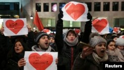 Demonstrators protest against a right wing demonstration at the Kaiser-Wilhelm-Gedaechtniskirche, in Berlin, Dec. 21, 2016, after a truck plowed through a crowd at a Christmas market Monday night.