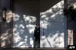A Chinese paramilitary soldier secures an entrance at the Jingxi Hotel in Beijing, Oct. 28, 2019.