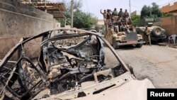 Members of Iraqi rapid response force ride in a military vehicle during a battle against Islamic State militants in Mosul, Iraq, May 20, 2017. 