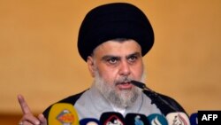 Iraqi Shiite cleric and political leader Moqtada al-Sadr delivers the Eid al-Fitr sermon during the Muslim holiday's morning prayer at the Grand Mosque of Kufa near the central shrine city of Najaf, June 5, 2019.