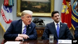 FILE - In this Sept. 5, 2018, file photo, then Speaker of the House Rep. Paul Ryan, R-Wis., listens to President Donald Trump speak during a meeting with Republican lawmakers in the Roosevelt Room of the White House in Washington.