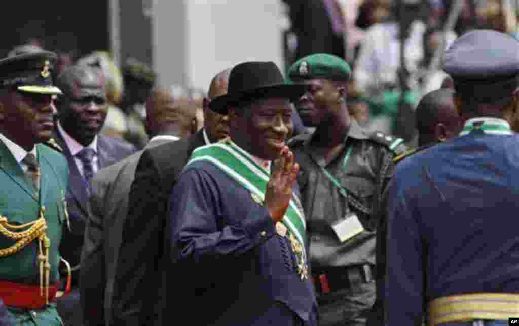 Goodluck Jonathan, center, waves as he arrives for his inauguration ceremony at the main parade ground in Nigeria's capital of Abuja, Sunday, May 29, 2011. Jonathan was sworn in Sunday for a full four-year term as president of Nigeria and is now faced wit