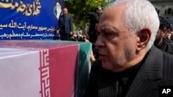 FILE - Mohammad Javad Zarif, now Iran's vice president for strategic affairs, pauses at the coffin of Foreign Minister Hossein Amirabdollahian, who was killed in a helicopter crash, on May 23, 2024, in Tehran. Zarif on Nov. 9 called on Donald Trump to reassess his stance on Iran.