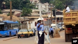 FILE - A police officer directs traffic in Yaounde, Cameroon.