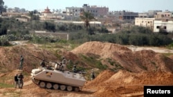 FILE -Egyptian soldiers stand guard outside smuggling tunnels beneath the Egyptian-Gaza border in Rafah, in the southern Gaza Strip February 19, 2013. 