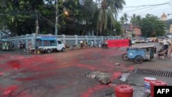 This photo taken by and received from an anonymous source via Facebook April 10, 2021, shows red paint splattered on the ground amid flyers promoting a student-led "Red Movement" in protest against the military coup in Yangon.