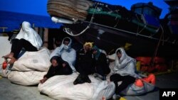 Les migrants sont assis à bord du MV Aquarius à destination de l'Italie le 9 mai 2018.