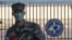 In this Feb. 21, 2020, photo, a South Korean marine wearing a mask stands in front of the Navy Base after a soldier of the unit was confirmed to have been infected with the coronavirus on Jeju Island, South Korea.