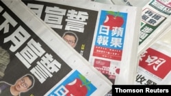 Copies of Next Digital's Apple Daily newspapers are seen at a newsstand in Hong Kong, June 17, 2021.