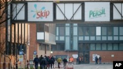 Workers inside the Unilever factory in Casalpusterlengo, near Lodi in Northern Italy, wait to be tested for virus infection Feb. 21,2020. 