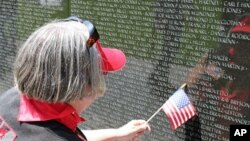 Beth Cullom finds the name of a family friend, John Barovetto, who was killed in Vietnam, 31 May 2010