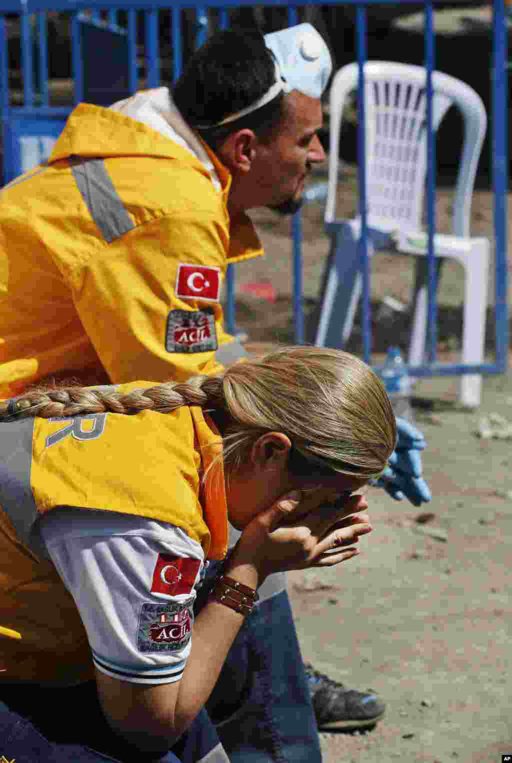 Members of the rescue team sit outside the coal mine, in Soma, western Turkey, May 15, 2014.