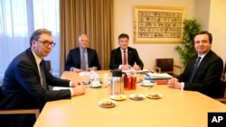 Serbian President Aleksandar Vucic, left, and Kosovo's Prime Minister Albin Kurti, right, meet with European Union foreign policy chief Josep Borrell, second left, in Brussels, Feb. 27, 2023. 