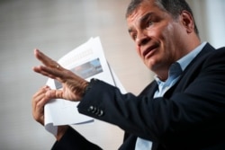 FILE - Former Ecuador President Rafael Correa talks during an interview with Associated Press in Brussels, Oct. 10, 2019.