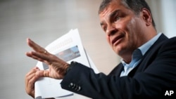 Former Ecuador President Rafael Correa talks during an interview with Associated Press in Brussels, Oct. 10, 2019. 