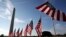 FILE - Small U.S. flags representing suicides of active and veteran members of the U.S. military line the National Mall, in Washington, Oct. 3, 2018.