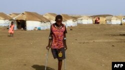 FILE —A picture taken on March 20, 2024, shows children who fled Khartoum and Jazira states in war-torn Sudan standing near tents at a camp for the internally displaced in southern Gadaref state.