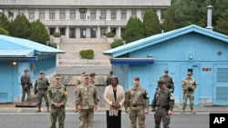 U.S. Ambassador to the United Nations Linda Thomas-Greenfield poses for photos with military officers at Panmunjom in the Demilitarized Zone dividing the two Koreas, Tuesday, April 16, 2024. 