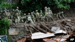 Rescuers continue a search operation at the site of a mudslide at Izusan in Atami, Shizuoka prefecture, southwest of Tokyo, July 5, 2021.