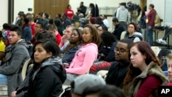 In this March 24, 2015 photo, University of Maryland students listen to speakers during a town hall meeting about racism in universities and what can be done to stop it, at University of Maryland in College Park, Md. 