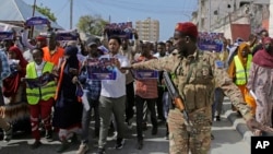 FILE - A Somali soldier controls the crowd as thousands of people rally in Mogadishu, Somalia, on Jan.3, 2024, protesting an agreement signed between Ethiopia and the breakaway region of Somaliland to give landlocked Ethiopia access to its shoreline. 