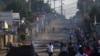 Residents walk past barricades that were used by protesters after the ruling Frelimo party was declared the winner of this month's disputed presidential election, in Maputo, Mozambique, Oct. 25, 2024.
