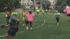 DC Scores summer camp participants and coaches celebrate a goal at the Tubman Elementary School playing field in Washington, D.C. (Photo by J. Nazar/VOA)