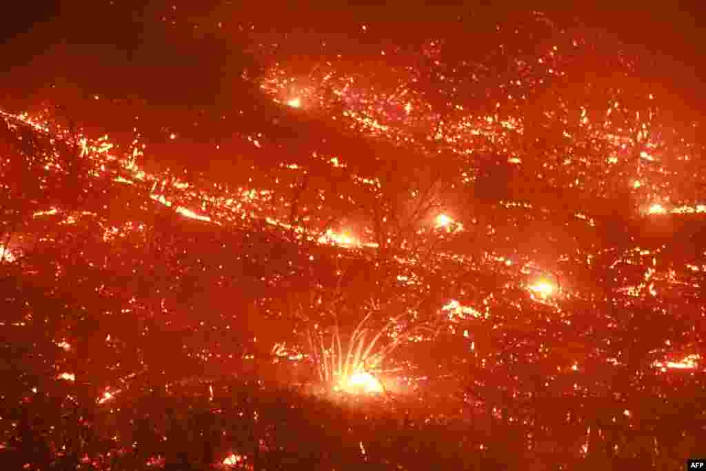 Embers fly through the air as Highway 330 is engulfed in flames from the Line Fire near Running Springs, California, Sept. 7, 2024.&nbsp;California Governor Gavin Newsom and San Bernardino County authorities declared a state of emergency. The Line Fire has burned more than 7,000 acres (2,800 hectares).