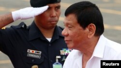 FILE - A soldier salutes as Philippine President Rodrigo Duterte arrives to take part during the change of command for the new Armed Forces chief at a military camp in Quezon city, Metro Manila, Dec. 7, 2016. 