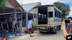 In this photo released by the San Sai District Administrative Office, journalists working for Democratic Voice of Burma, prepare to get into a van after being arrested at San Sai District in Chiang Mai province north of Thailand Sunday, May 9, 2021.