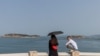 FILE - People stand on a viewing platform overlooking the Taiwan strait on Pingtan Island, Fujian province, China, April 10, 2023. 