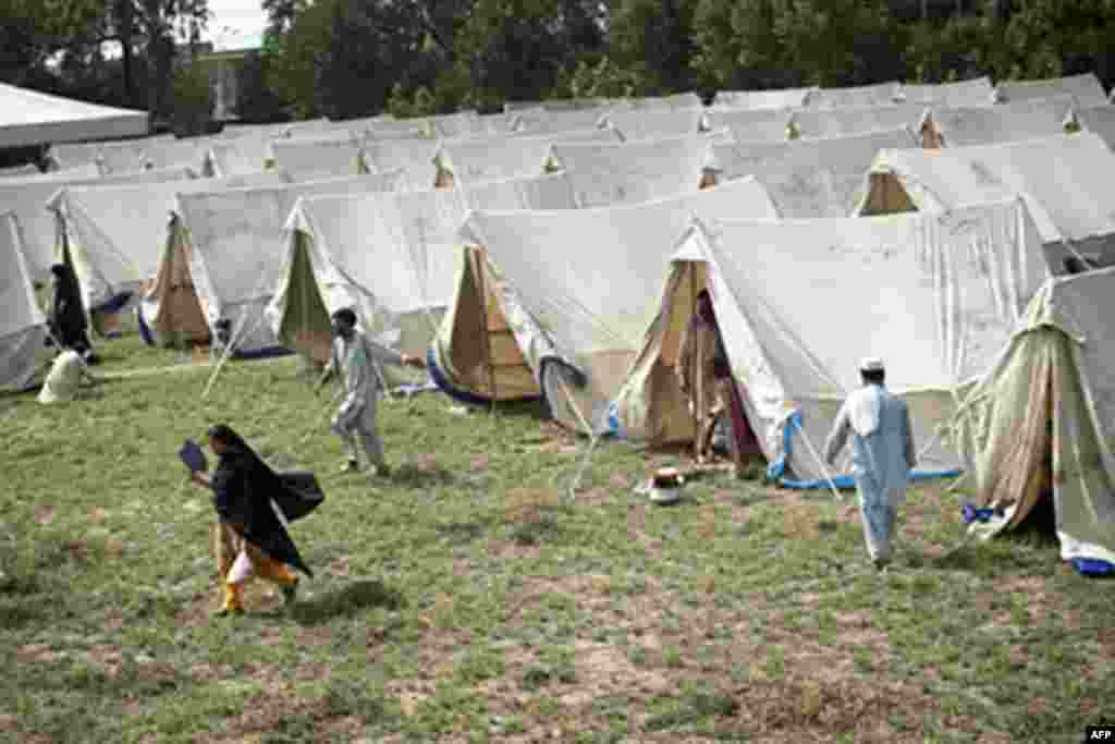 Displaced Pakistanis mill about a tent camp set up by the army inside a college on the outskirts of Nowshera on August 2, 2010. Fears were growing Monday for up to 2.5 million people affected by Pakistan's worst floods in 80 years amid outbreaks of diseas