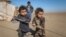 Internally displaced Syrian children who fled Raqqa city stand near their tent in Ras al-Ain province, Syria, Jan. 22, 2017. UNICEF is earmarking $1.4 billion to go toward helping 17 million children and families caught up in war inside Syria and living as refugees in five neighboring countries.