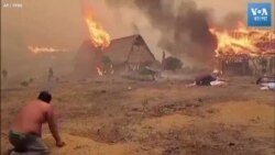 বলিভিয়ায় পুড়ে যাওয়া বাড়িঘর থেকে জিনিসপত্র উদ্ধার করছে মানুষ