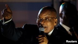 South Africa's President Jacob Zuma celebrates with his supporters after he survived a no-confidence motion in parliament in Cape Town, South Africa, Aug. 8, 2017.