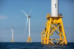 FILE - Three of Deepwater Wind's five turbines stand in the water off Block Island, R.I, the nation's first offshore wind farm, Aug. 15, 2016.