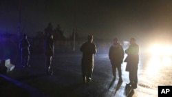 Security forces block a road at the site of a suicide bomb attack in Kabul, Afghanistan, Nov. 28, 2018. 