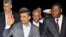 Iranian President Mahmoud Ahmadinejad (2nd L) waves next to Benin's President Thomas Boni Yayi (R) as he arrives in Cotonou April 14, 2013.