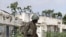 A Ugandan African Union peacekeeper patrols an empty street in the Wardigley district of southern Mogadishu, August 7, 2011